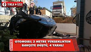 Otomobil 2 metre yükseklikten bahçeye düştü