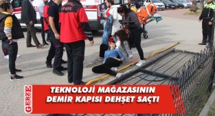 Demir kapı güvenlikçi kadının üzerine devrildi