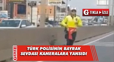 Yere düşen bayrak için trafiği durdurdu