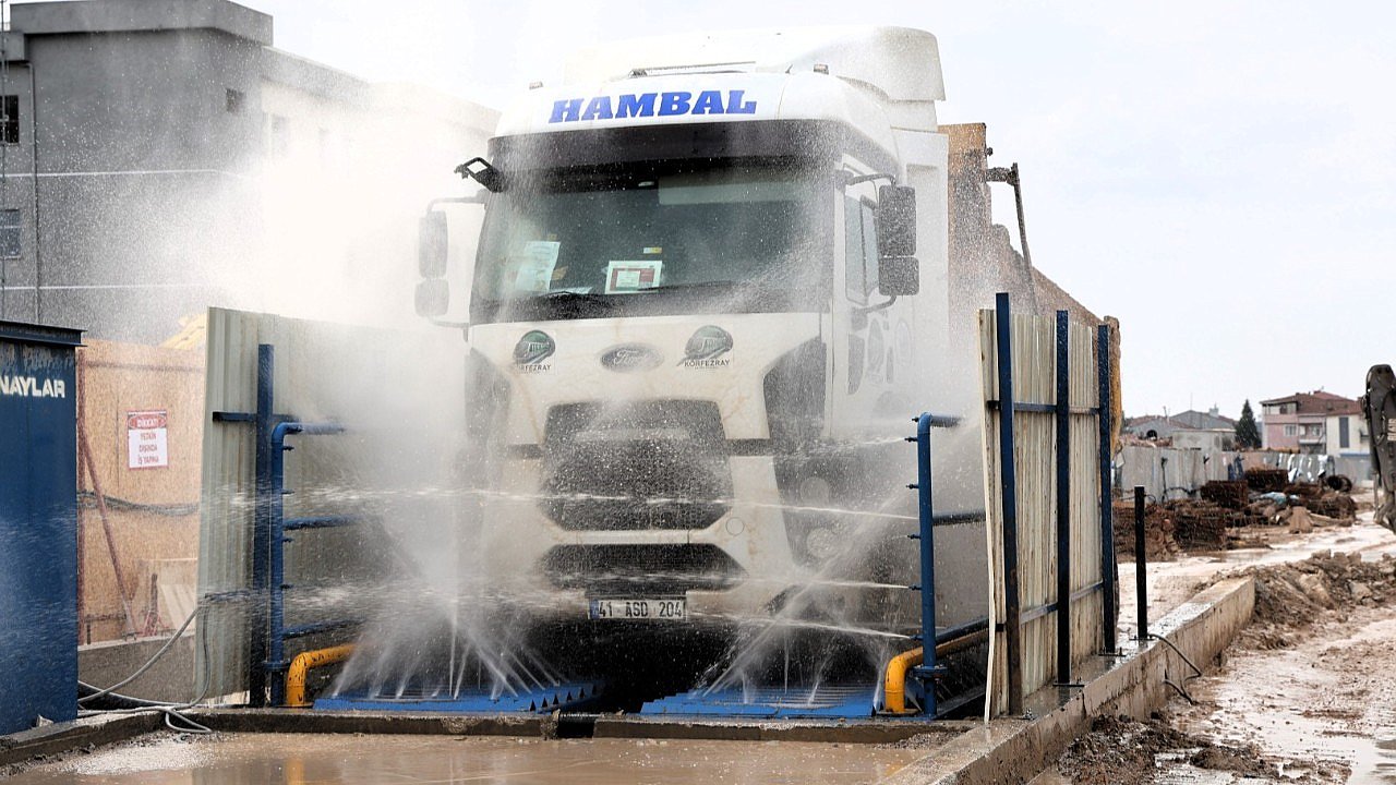 Şantiyeden çıkan araçlar temizlendikten sonra trafiğe karışıyor